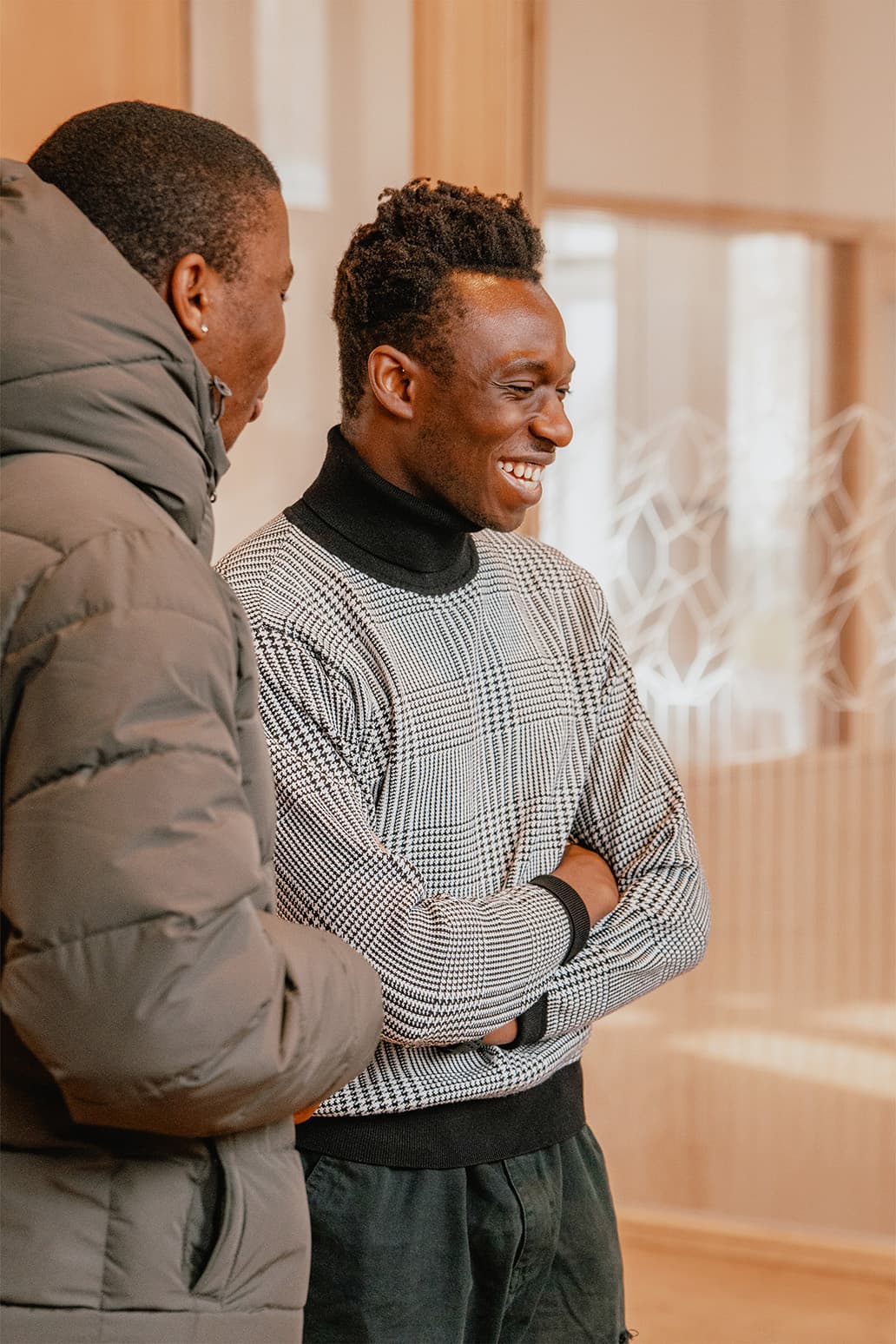 A pastor chatting warmly with members after the service