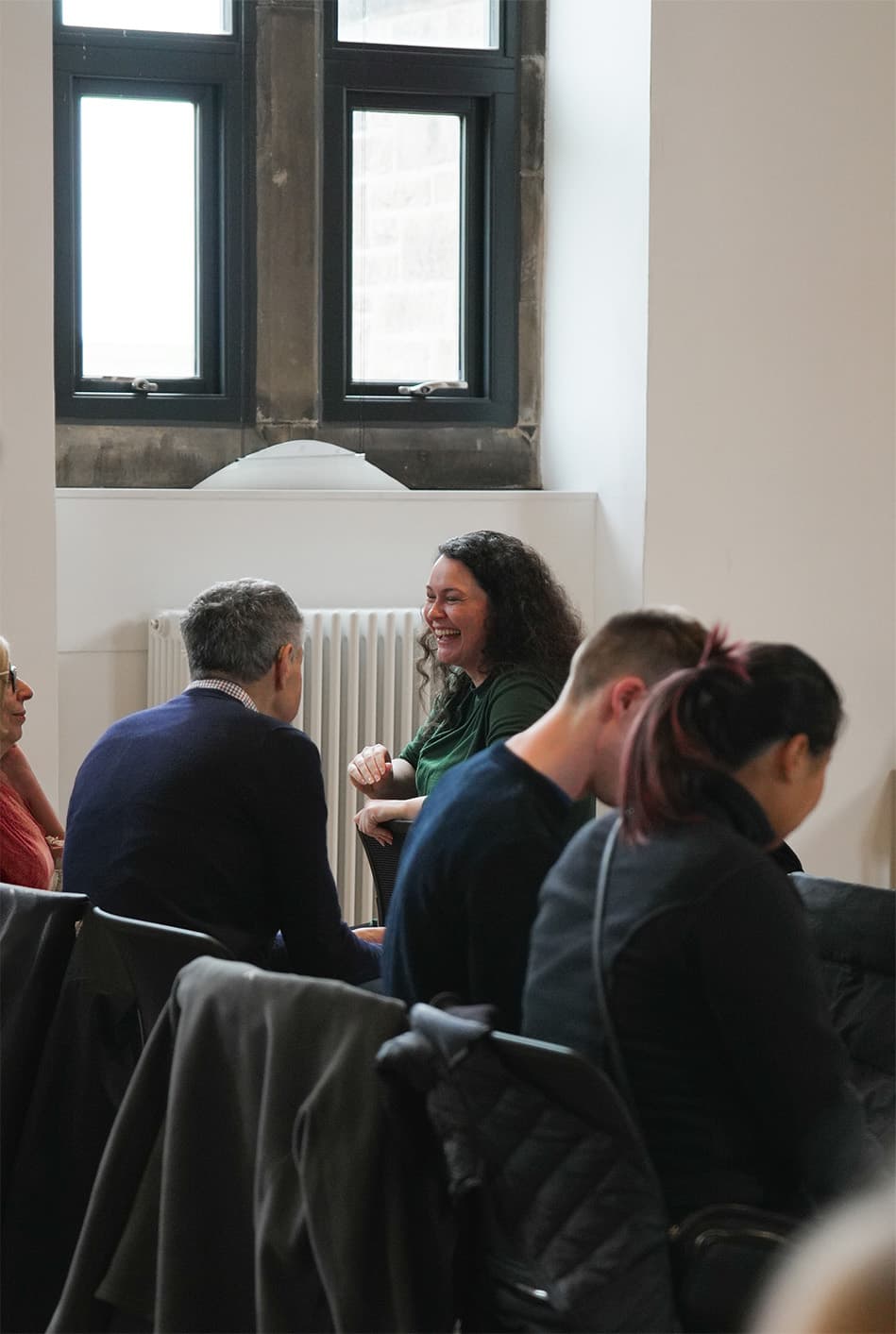 Two members of C3 Edinburgh laughing together after a service