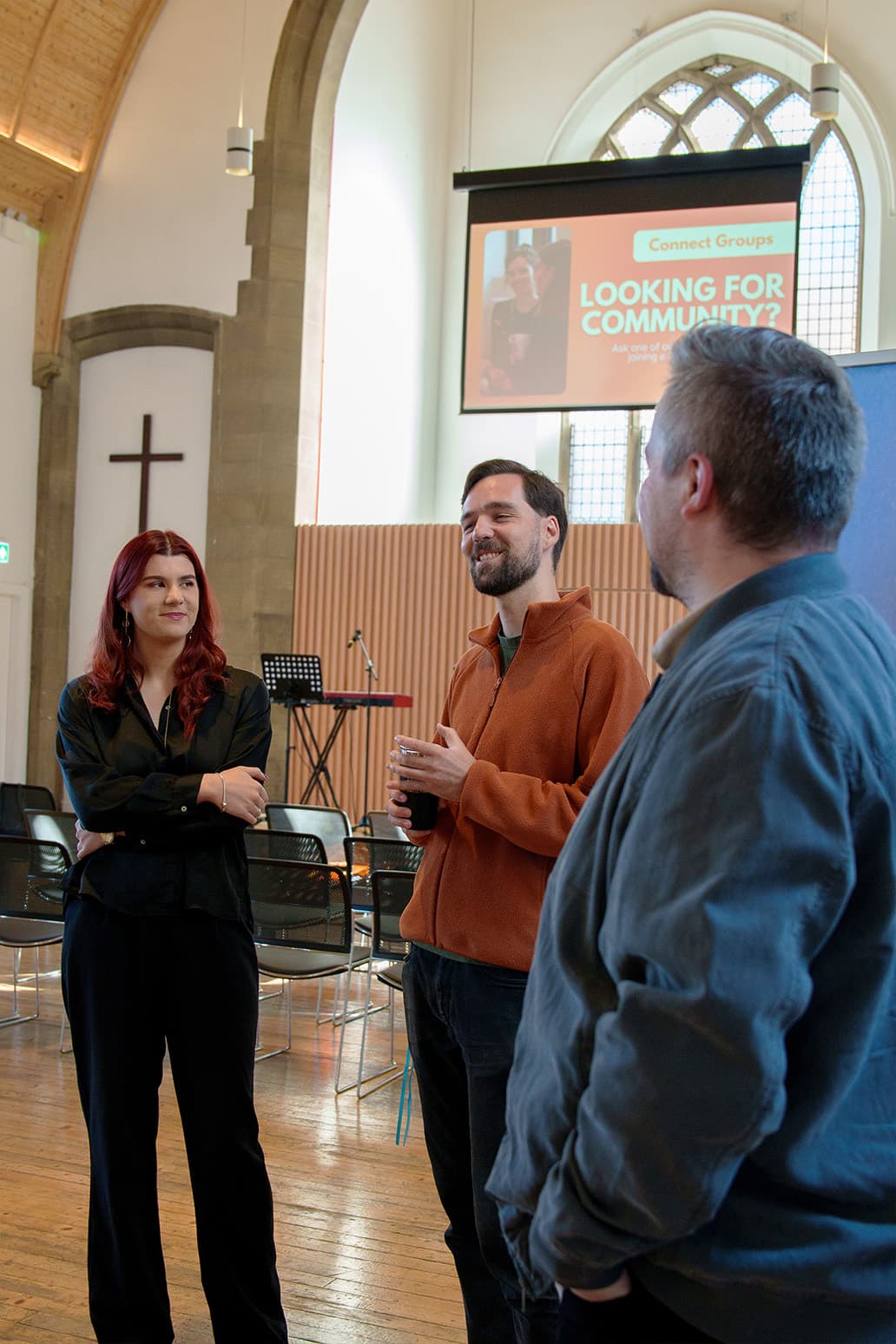 A group of friends chatting in the hall after a service
